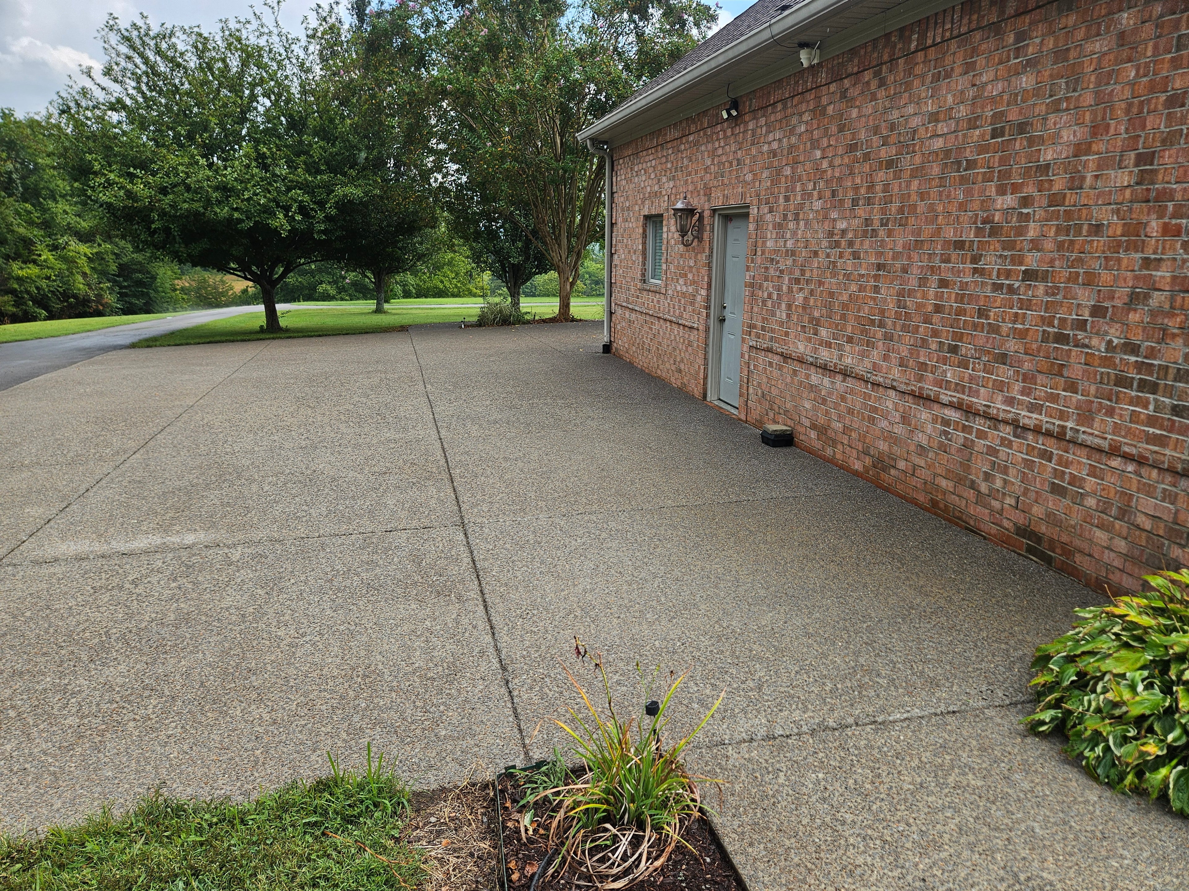 After: Concrete driveway before and after cleaning and sealing
