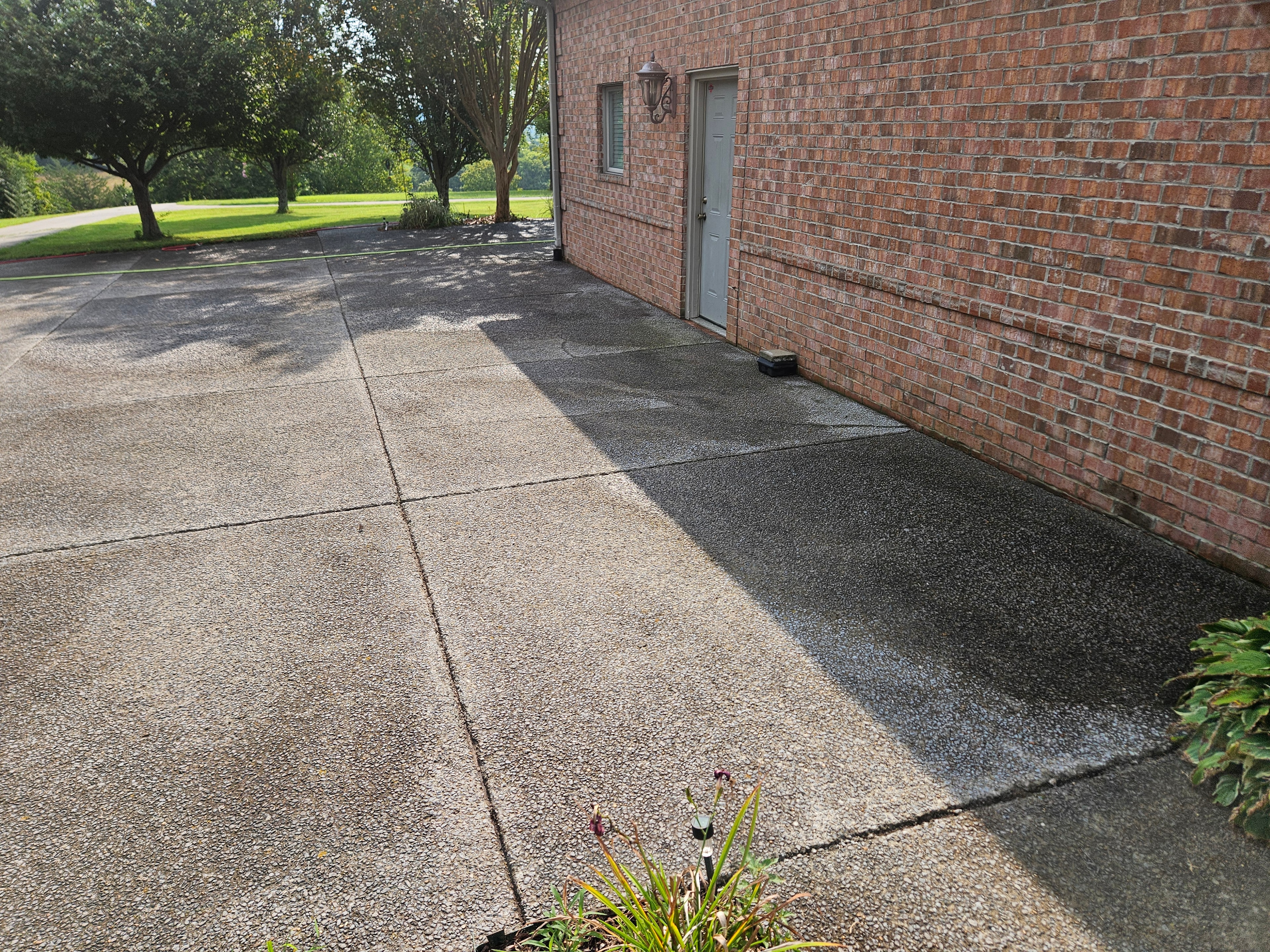Before: Concrete driveway before and after cleaning and sealing